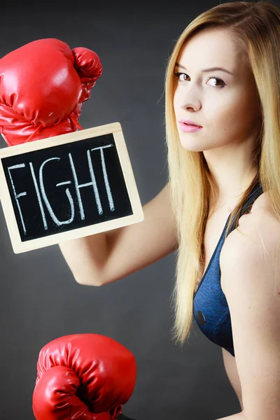 Woman wearing boxing glove holding fight sign — Stock Photo, Image