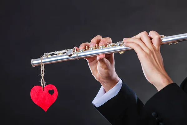 Male flutist with flute and heart. Love melody — Stock Photo, Image