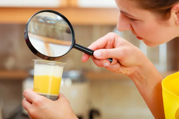 Vrouw inspectie voedsel met Vergrootglas. — Stockfoto