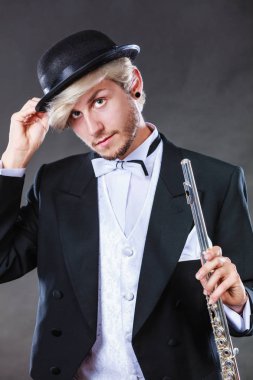 Zarif giyimli müzisyen flüt tutan