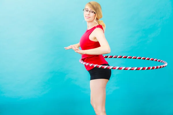 Adatto donna con hula hoop facendo esercizio — Foto Stock