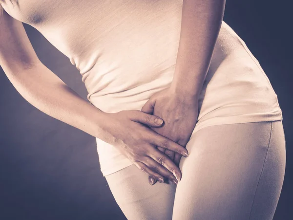 Woman with hands holding her crotch — Stock Image Woman with hands holding her crotch Stock Photo