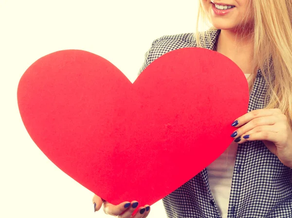 Mujer sosteniendo gran corazón rojo, signo de amor — Foto de Stock