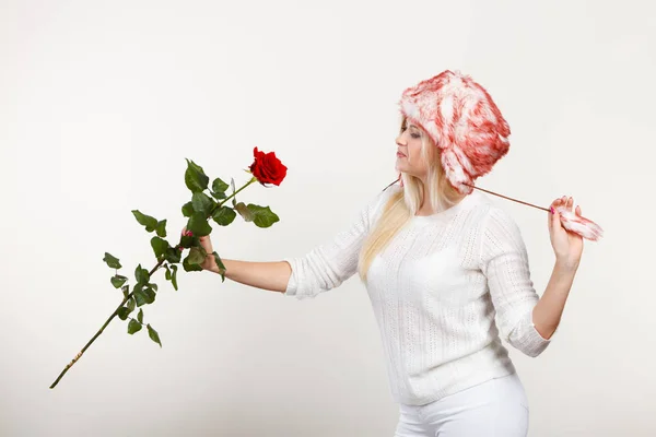 Donna in inverno cappello peloso in possesso di rosa rossa — Foto Stock