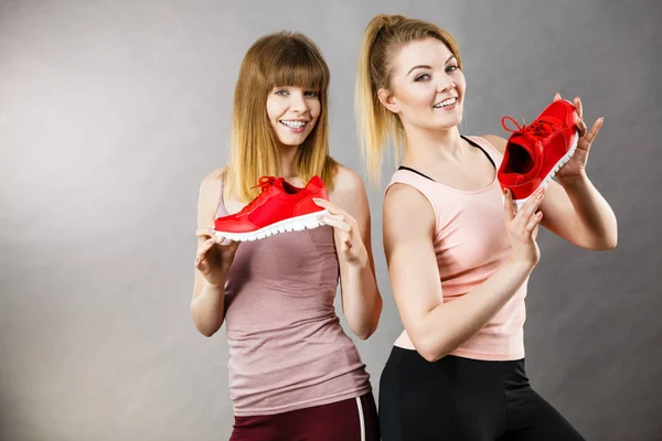 Zwei Frauen präsentieren Sportbekleidung Turnschuhe — Stockfoto