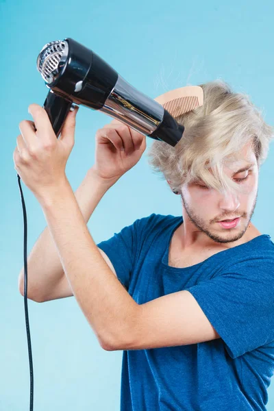 Trendy man with hair dryer