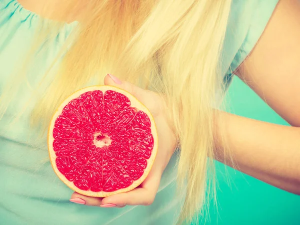 Женщина с красным грейпфрутом — стоковое фото