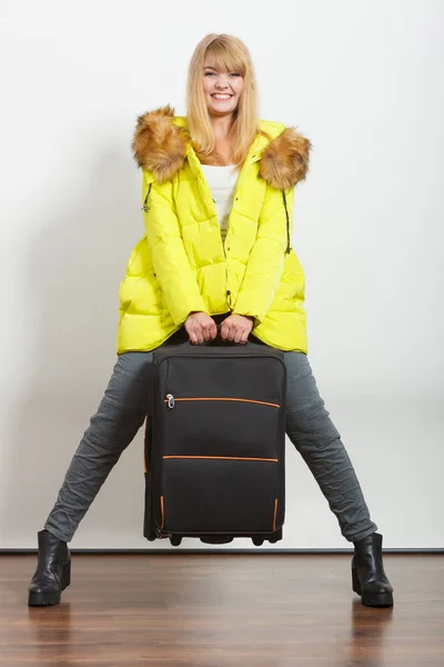 Happy young woman in warm jacket with suitcase. — Stock Photo, Image