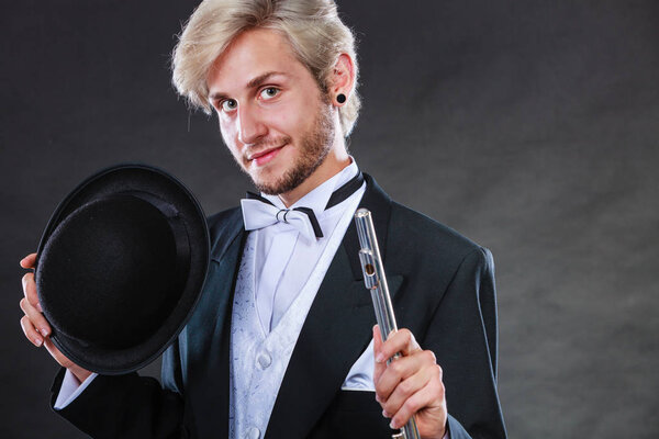 Elegantly dressed musician holding flute