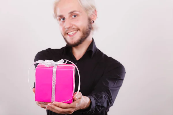man holding present pink gift box in hand