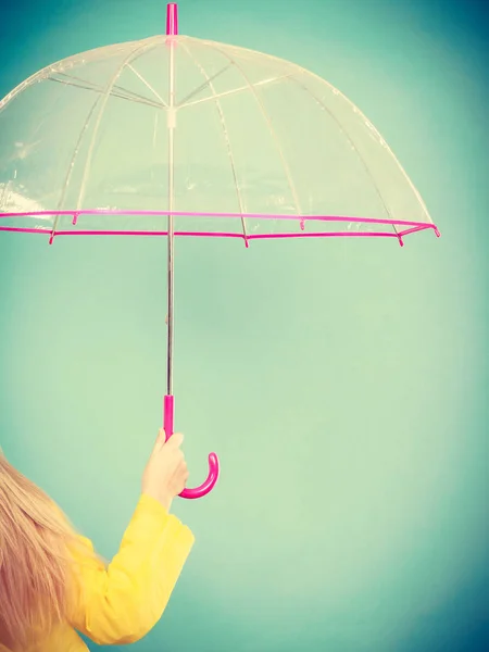 Woman hand holding transparent umbrella