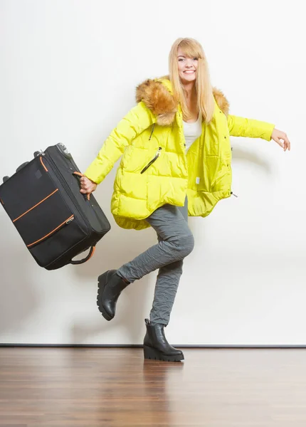 Happy young woman in warm jacket with suitcase. — Stock Photo, Image