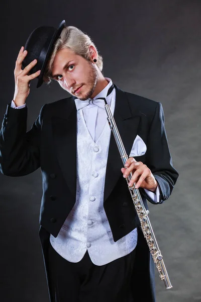 Elegantly dressed musician holding flute — Stock Photo, Image