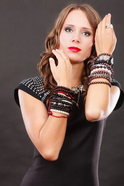 Woman with jewellery in black evening dress — Stock Photo, Image