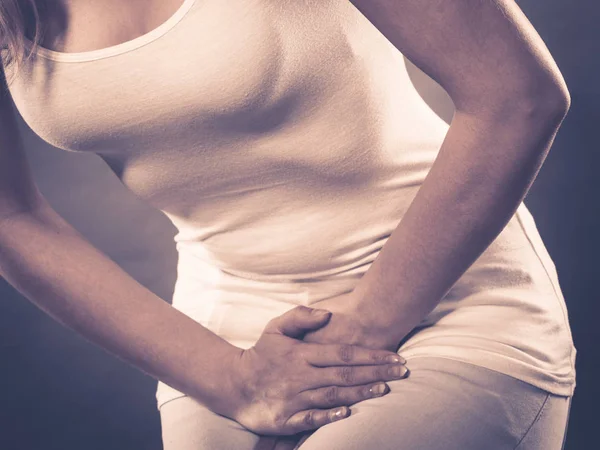 Woman with hands holding her crotch — Stock Image Woman with hands holding her crotch Royalty Free Stock Photos