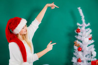 Noel Baba şapkası kanepe rahatlatıcı üzerinde oturan kadın