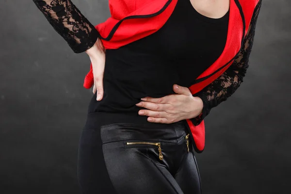 Woman in red shirt having stomach ache — Stock Photo, Image