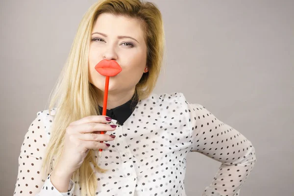 Happy woman holding fake lips on stick — Stock Photo, Image