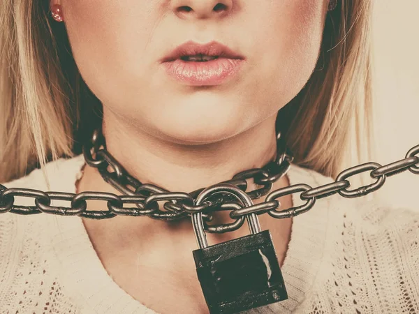 Woman having metal chain around neck