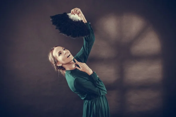 Vintage lady with feather fan on dark — Stock Photo, Image