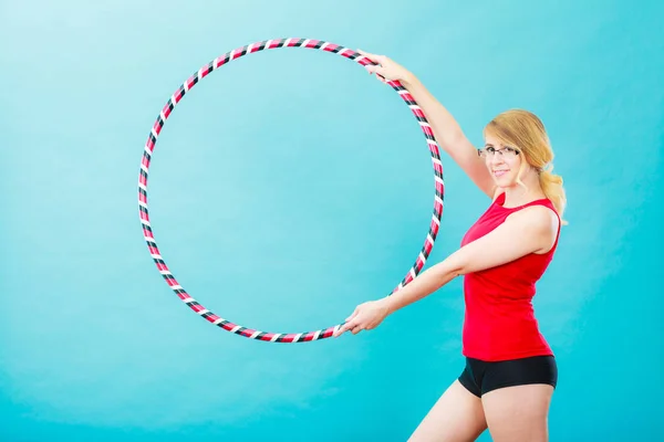 Adatto donna con hula hoop facendo esercizio — Foto Stock