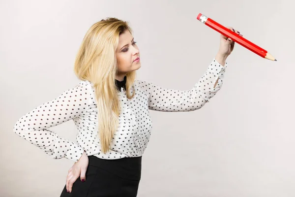 Positive woman holds big pencil in hand — Stock Photo, Image