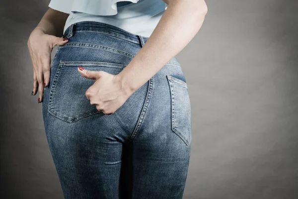 Woman hips buttocks in jeans clothing