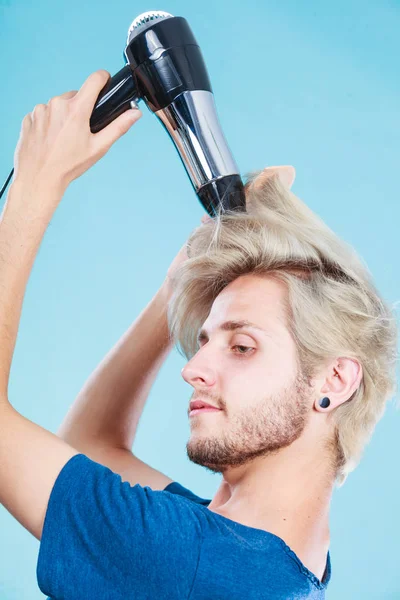 Trendy man with hair dryer