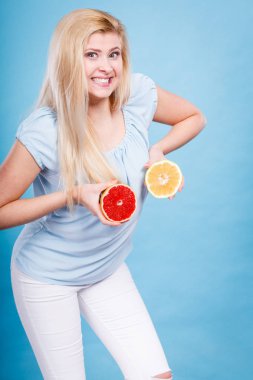 Kırmızı ve yeşil greyfurt tutan kadın