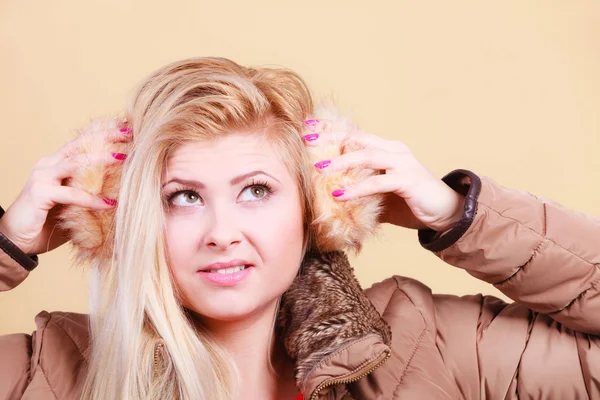 Blonde woman in winter earmuffs and jacket. — Stock Photo, Image