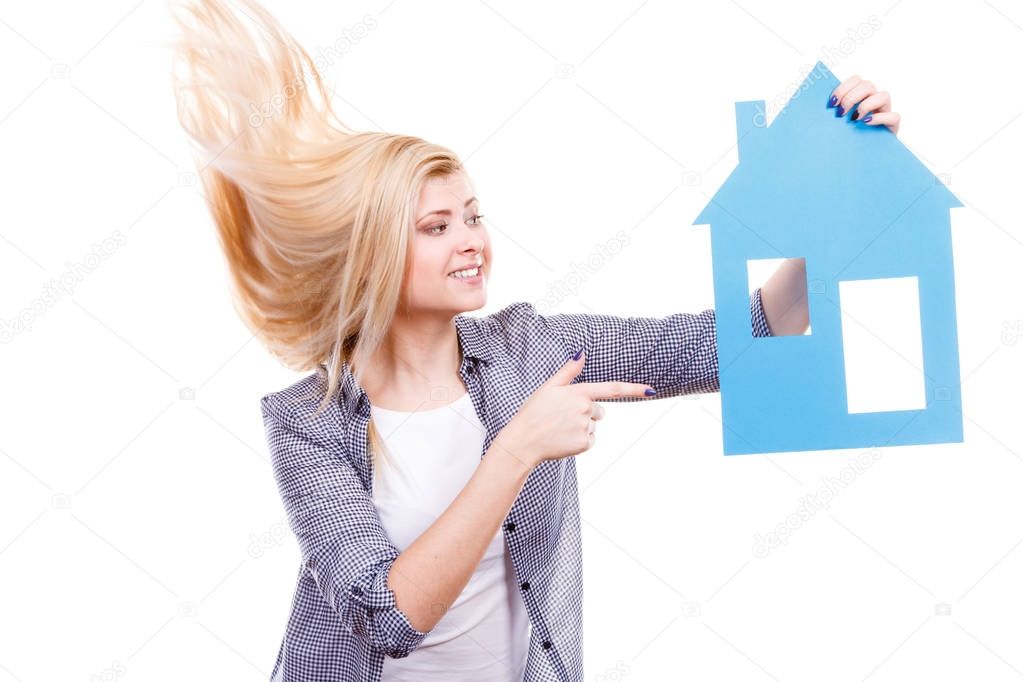 Happy woman holding blue paper house