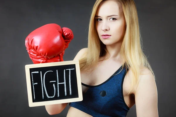 Woman wearing boxing glove holding fight sign — Stock Photo, Image