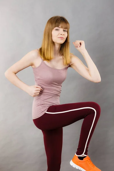 Woman working out at home stretching body — Stock Photo, Image