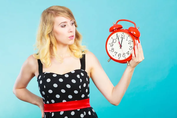 Chica seria con despertador en azul . — Foto de Stock