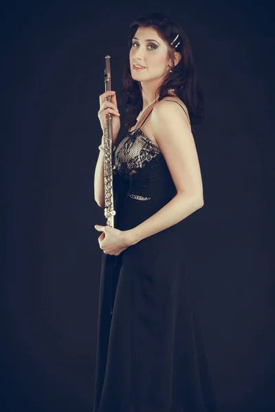 Elegant woman with flute instrument.