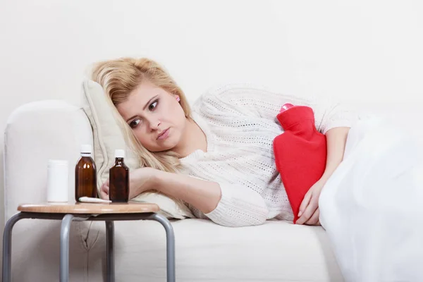 Femme se sentant crampes d'estomac couché sur cofa — Photo