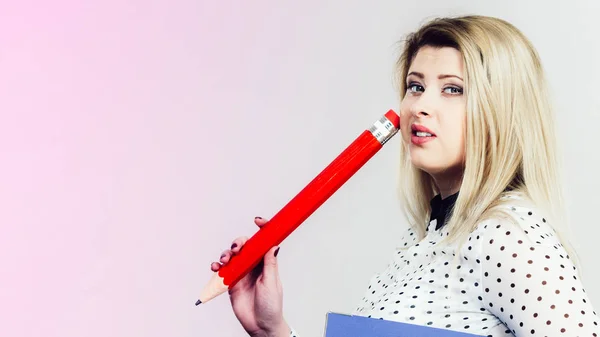 Woman holding big pencil — Stock Photo, Image