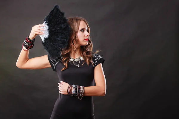 Beautiful brunette woman with black fan in hand — Stock Photo, Image