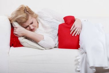 Cofa üzerinde yatan kadın duygu mide krampları