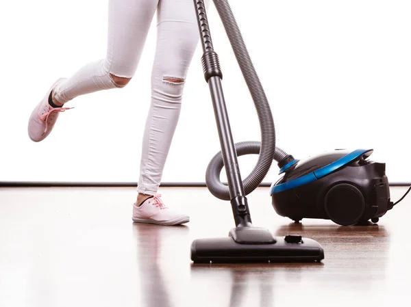 Woman legs and vacuum cleaner — Stock Photo, Image