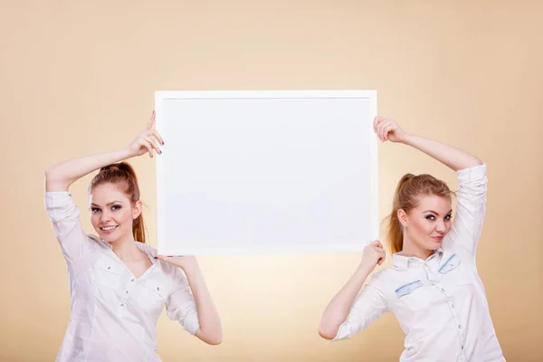Two girls with blank presentation board — Stock Photo, Image