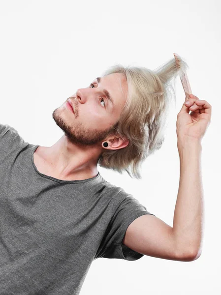 Man with stylish haircut combing his hair — Stock Photo, Image