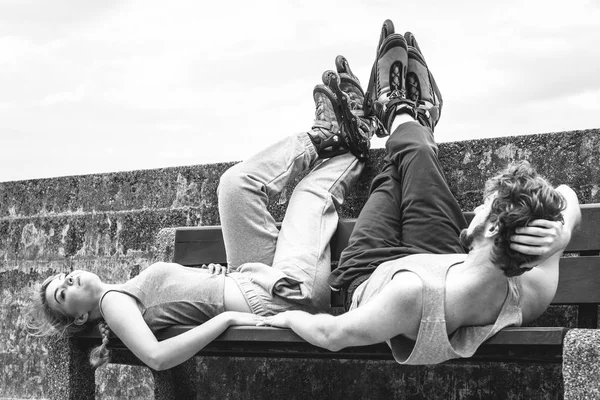 Jovens cansados amigos relaxando no banco . — Fotografia de Stock