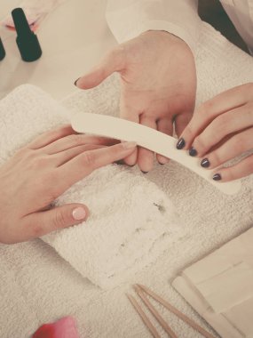 Manikür yaptıran kadın dosya çivileri.