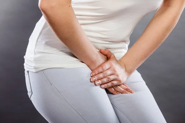 Woman with hands holding her crotch — Stock Image Woman with hands holding her crotch Stock Picture