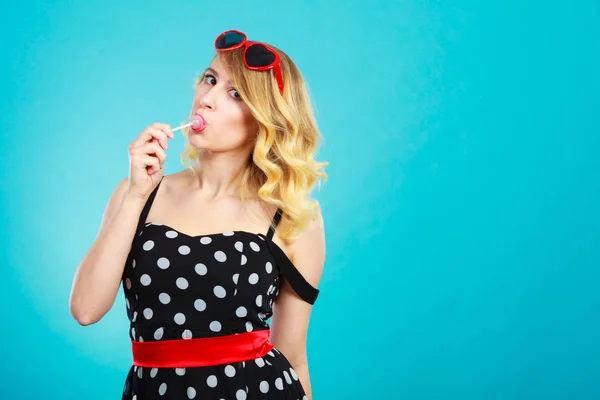 Cheerful girl holding little lollipop candy in hand — Stock Photo, Image