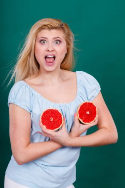 Kadın greyfurt narenciye meyve meme üzerinde tutar