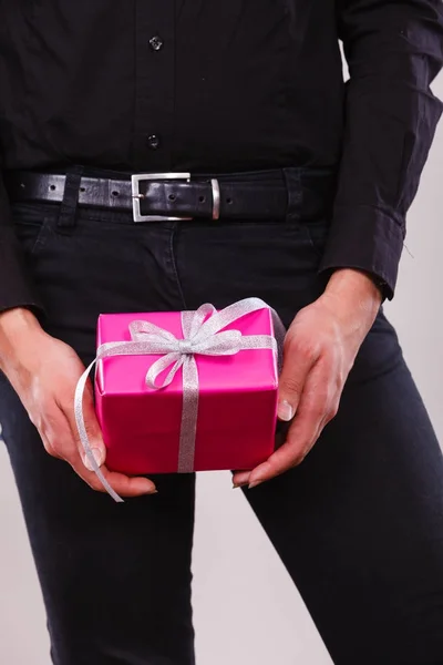 Man holding present pink gift box in hands — Stock Photo, Image