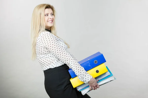 Woman holding heavy colorful binders with documents — Stock Photo, Image