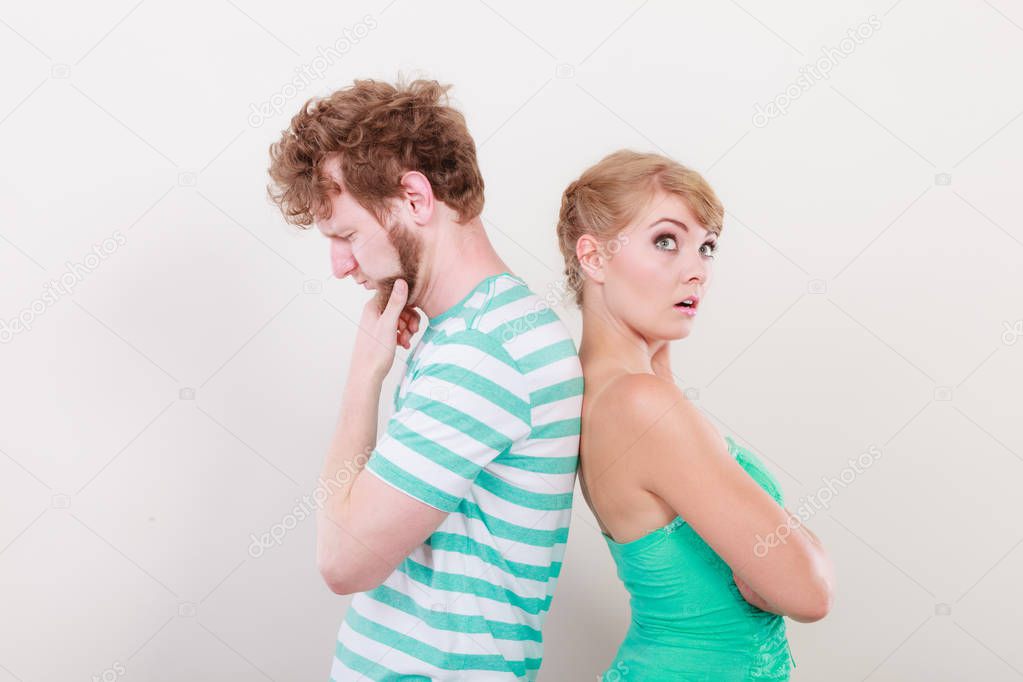 Young couple after quarrel offended back to back